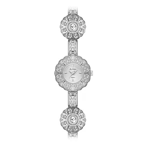 Elegant flower-shaped silver bracelet watch with rhinestones for a vintage luxury look.