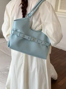 Stylish light blue faux leather shoulder bag for women with decorative buckle belt design.
