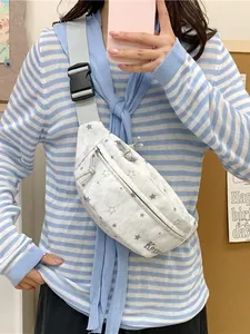 Casual light gray fanny pack with star pattern and adjustable strap worn by model