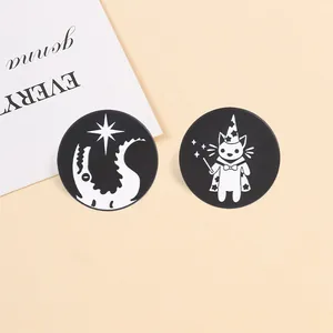 Close-up of wizard cat and dragon themed black and white round metal badges