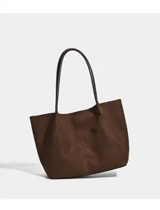 Detailed side view of large brown suede tote bag showing its vintage texture and shape