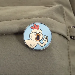 Close-up of a funny cartoon chicken enamel pin with OK gesture on a canvas bag