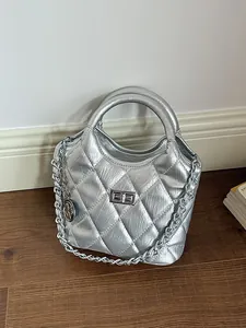 Sophisticated silver quilted metallic bucket bag with chain strap and top handle