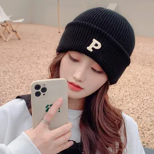 Stylish black knitted beanie featuring white P embroidery patch for winter warmth