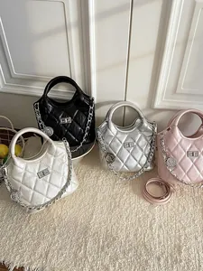 Fashionable quilted crossbody bucket bag with silver chain and coin charm detail