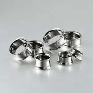 Close-up of polished silver G23 titanium steel internal thread double flare ear gauges