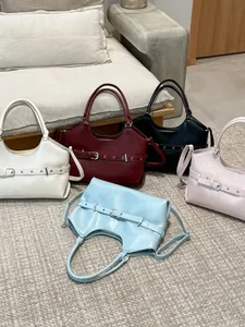 Collection of stylish women's tote bags in five colors with unique belt buckle detailing