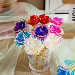 Detailed macro view of colorful iridescent gold foil roses arranged in a textured glass vase