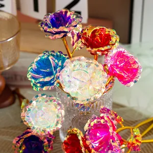 Detail shot of colorful iridescent 18cm gold foil artificial roses in a clear glass vase.
