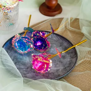 Macro view of iridescent gold foil roses with shimmering holographic petals and gold stems