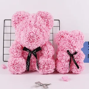 Two beautiful handmade pink foam rose bear figurines with black decorative ribbons