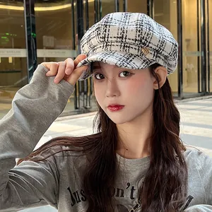 Women's chic black and white plaid newsboy cap for autumn and winter fashion.