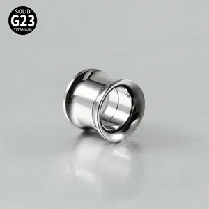 Macro detail of G23 solid titanium double flared ear gauge with a high-polished silver finish