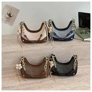 Detail view showing four color variations of the chic crescent chain handbags