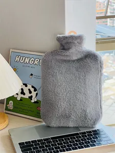 Detailed view of soft grey faux fur hot water bottle on a desk for winter warmth