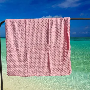 Gros plan sur une couverture rose à pois minky avec texture douce gaufrée
