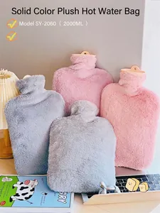 Close-up of fluffy faux rabbit fur plush covers for hot water bottles in grey and pink