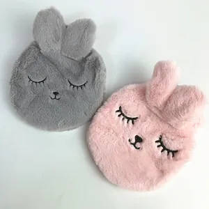 Close-up of soft plush rabbit ear hot water bottle covers in grey and pink faux fur