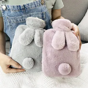 Pair of soft plush bunny-eared hot water bottles in grey and pink for winter warmth