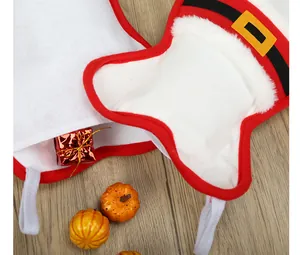 Close-up detail of bone-shaped Christmas stockings for pets with Santa belt design