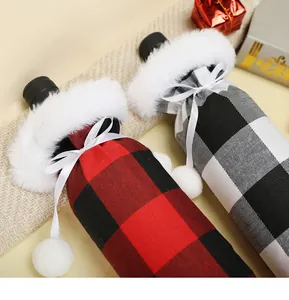 Detail of red and black plaid Christmas wine bottle covers with white faux fur trim