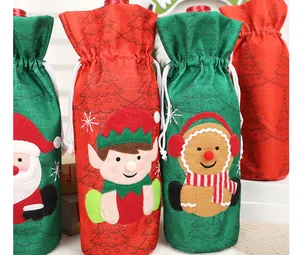 Detailed view of Christmas burlap wine bottle bags with Santa, Elf, and Gingerbread man motifs