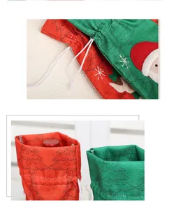 Detailed view of burlap Christmas wine bottle covers with drawstring and festive patterns