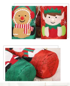 Close-up of festive Christmas wine bottle covers with gingerbread and elf appliques