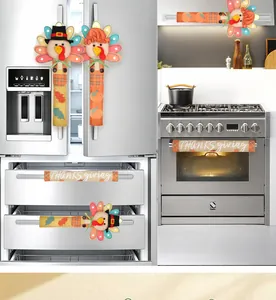 Set of Thanksgiving turkey handle covers displayed on a stainless steel refrigerator and oven