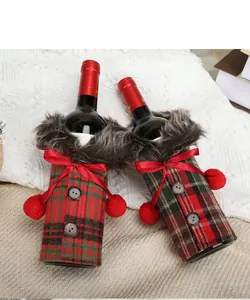 Festive plaid wine bottle covers with red bows and faux fur for Christmas table decor
