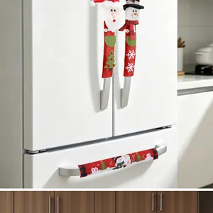 Close-up of Santa and snowman Christmas refrigerator handle covers on white fridge.