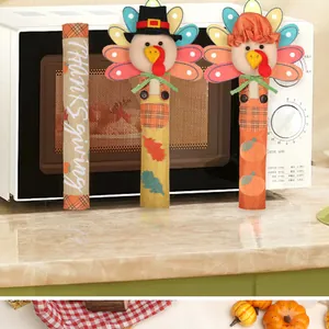 Close-up of turkey character handle covers displayed on a white microwave oven handle