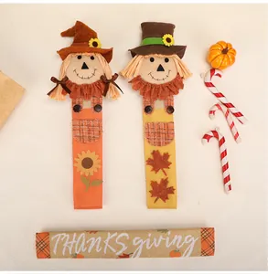 Detailed view of Thanksgiving scarecrow refrigerator handle covers set with maple leaf