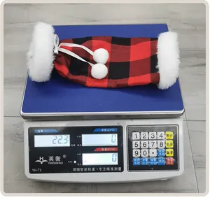 Detailed view of the 22.3g lightweight red and black plaid Christmas wine bottle sleeve