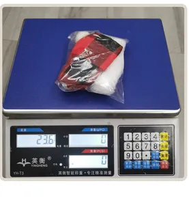 Weight measurement of the red and black plaid Christmas wine bottle cover on a digital scale