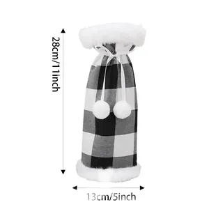 Black and white buffalo plaid Christmas wine bottle cover with white fur trim and pom-poms