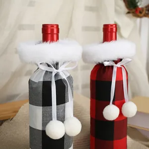 Festive plaid Christmas wine bottle covers with white fur trim and pom-pom ties.