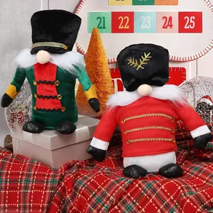 Two festive Christmas gnome soldier plush dolls on a red plaid blanket decorations