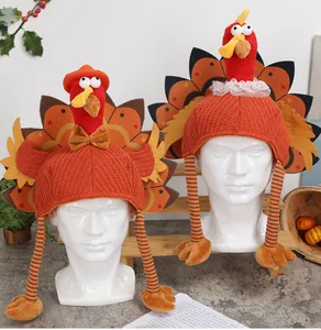 Detail of two creative turkey hats on mannequins for Thanksgiving decor.