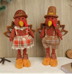 Pair of plush Thanksgiving turkey dolls with plaid outfits and wings on a white furry floor