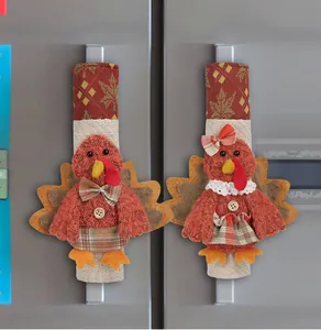 Close-up of Thanksgiving turkey refrigerator handle covers with plaid fabric details.