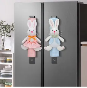 Decorative plush cartoon rabbit refrigerator handle covers displayed on a silver fridge