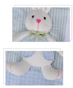 Detailed view of plush Easter rabbit refrigerator handle cover with blue plaid vest and green bow.