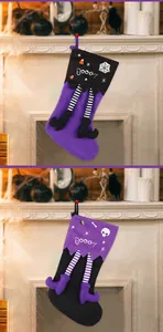 Detail view of large Halloween stockings with witch legs and skull print hanging on fireplace.