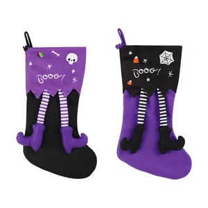 Set of two festive Halloween stockings featuring striped legs and 'Booo!' print design
