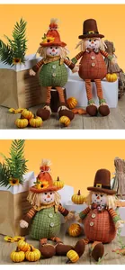 Close-up detail of two cute harvest scarecrow dolls with sunflowers and decorative pumpkins.