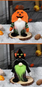 Close-up of Halloween pumpkin and black cat gnome plush ornaments on rustic wood base
