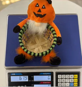 Close-up of Halloween gnome pumpkin basket on a digital scale weighing 67.9 grams