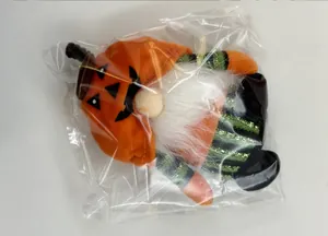 Halloween gnome plush ornament with pumpkin hat shown in its protective clear plastic bag