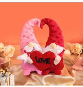 Detailed shot of plush Valentine's Day gnomes set holding a red heart with LOVE text